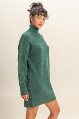 woman wearing a green turtleneck sweater dress with long sleeves and a relaxed fit