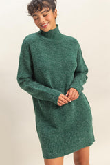 woman wearing a green knit turtleneck sweater dress with long sleeves and ribbed hem
