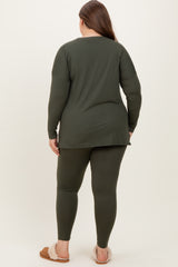 woman wearing an olive green maternity plus long sleeve top and matching leggings, showing a visible baby bump from behind
