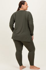 woman wearing a dark green long sleeve top and matching leggings, shown from the back