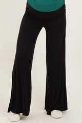woman wearing black maternity wide-leg pants with a comfortable waistband and relaxed fit
