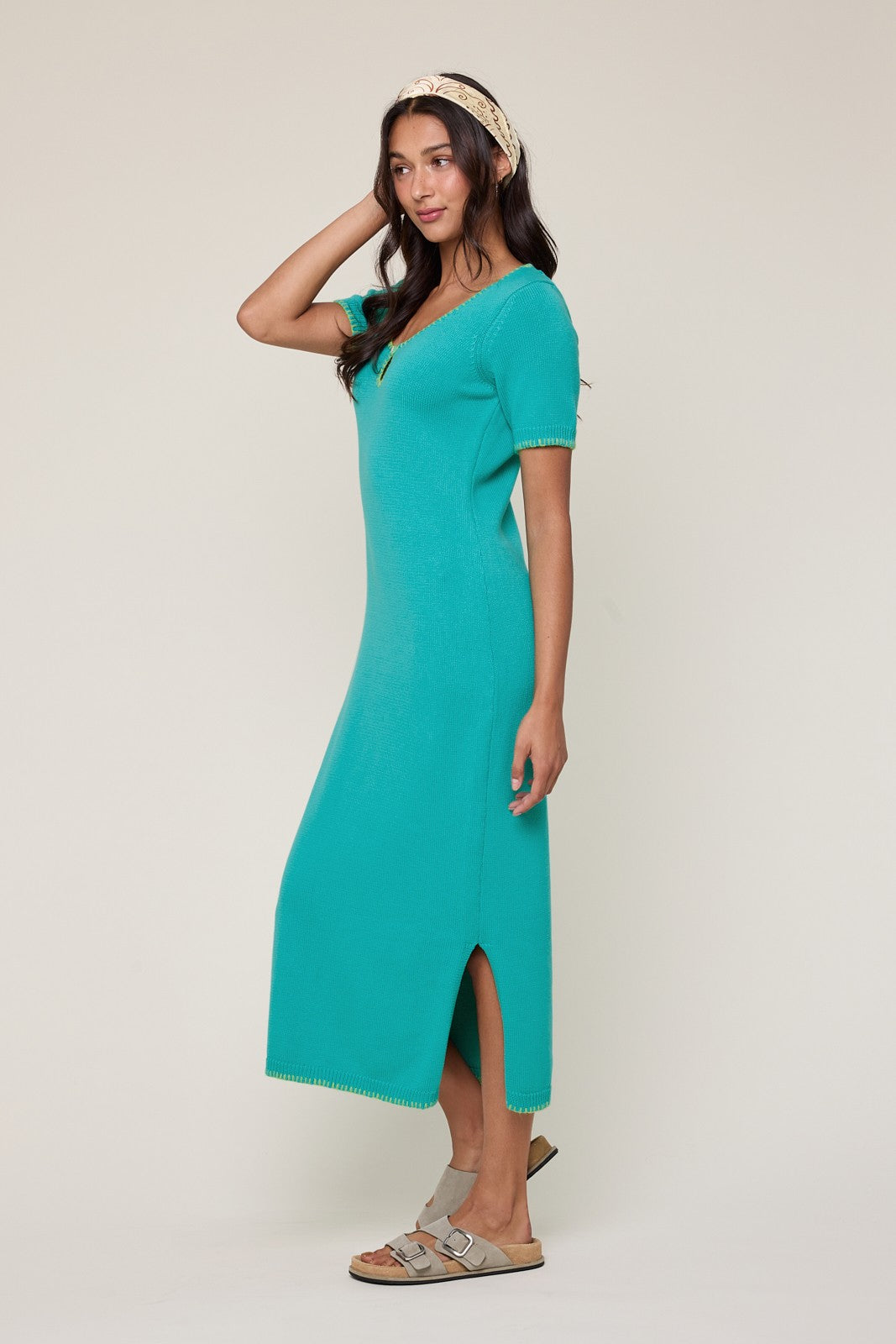 woman wearing a teal short sleeve maxi dress with side slits and a relaxed fit