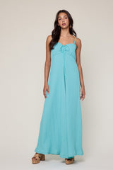 woman wearing a light blue maxi dress with a tie front and spaghetti straps