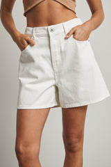 woman wearing white denim shorts with front pockets and a high waist