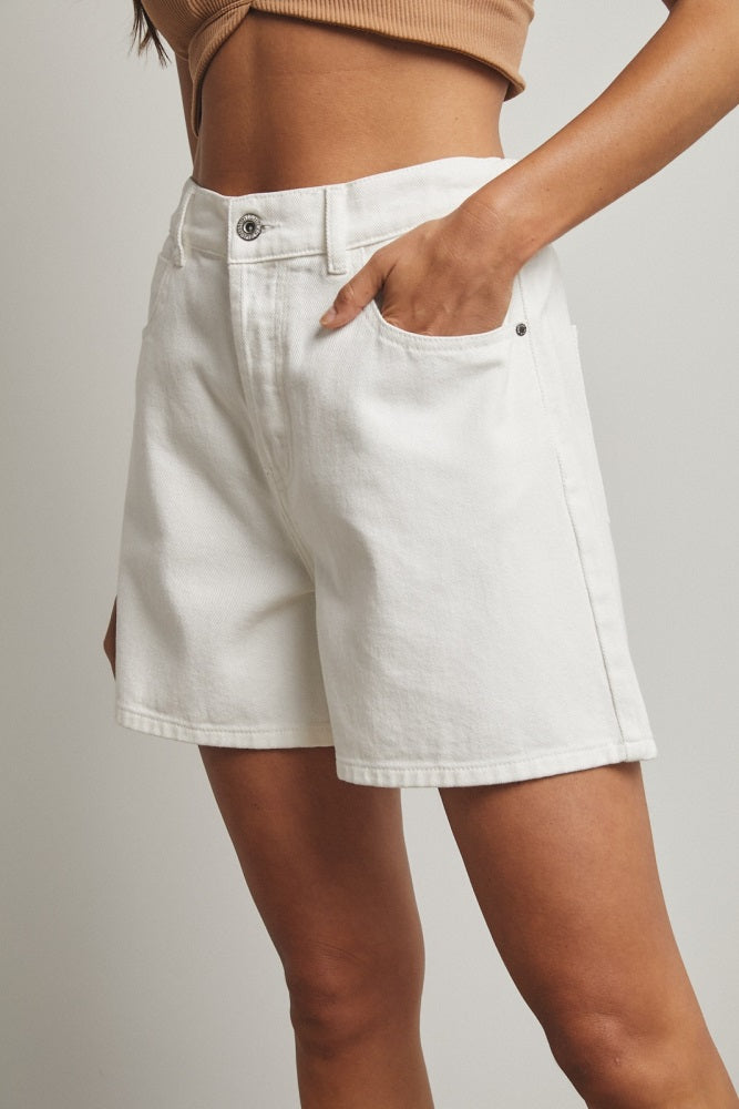 woman wearing white denim shorts with a fitted waist and side pockets