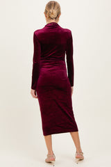 woman wearing a burgundy long sleeve maternity dress with a bodycon fit and mid-calf length