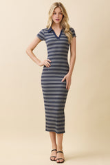 woman wearing a navy and white striped midi dress with a v-neck and short sleeves