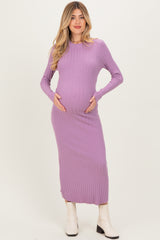 woman wearing a lavender long sleeve ribbed maternity dress and holding her baby bump