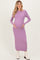 woman wearing a lavender long sleeve ribbed maternity dress and holding her baby bump