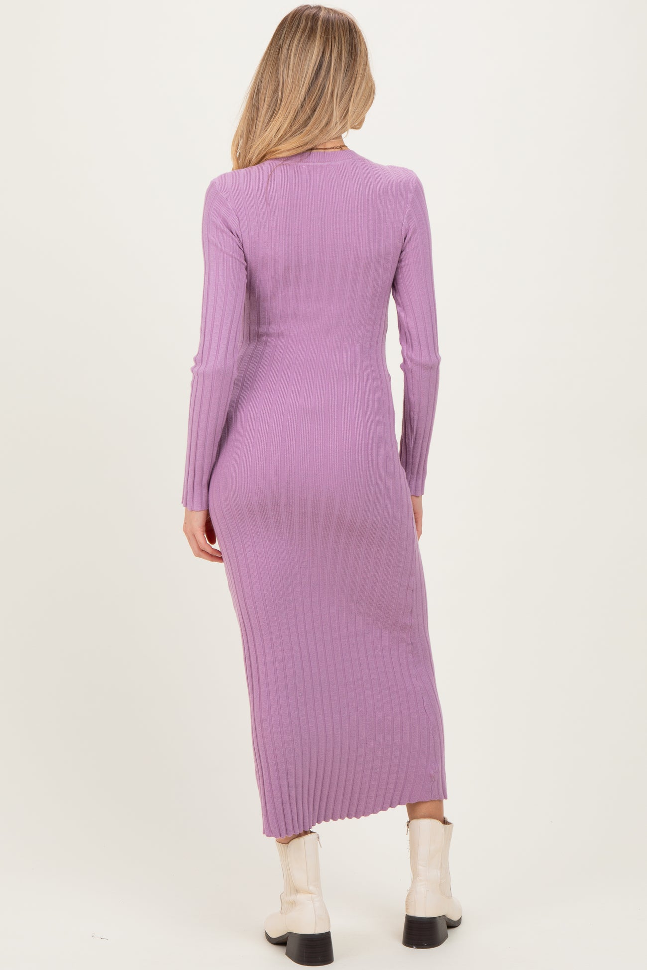 woman wearing a long sleeve lavender ribbed maternity dress, showing a fitted silhouette from the back