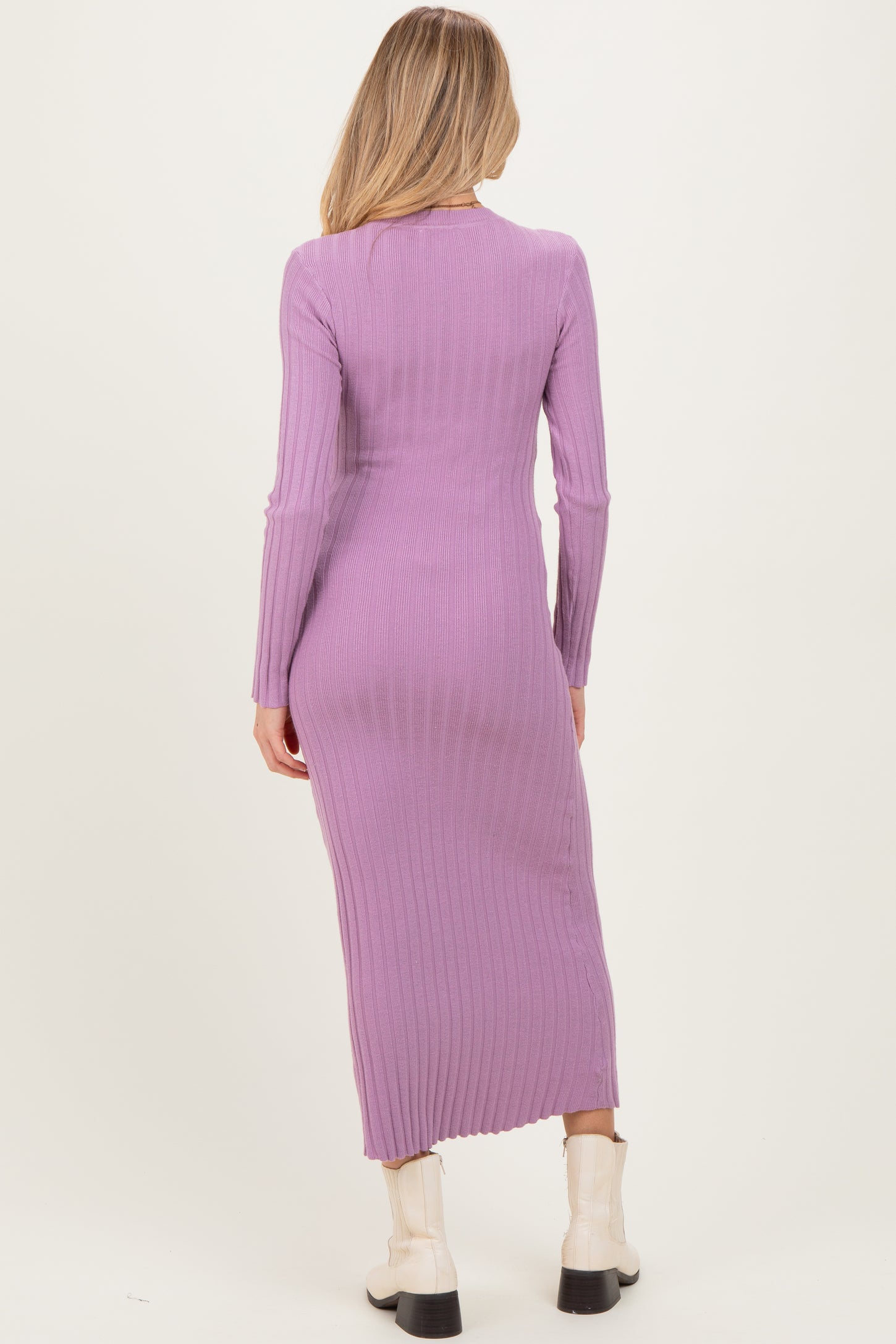 woman wearing a long sleeve lavender ribbed maternity dress, showing a fitted silhouette from the back