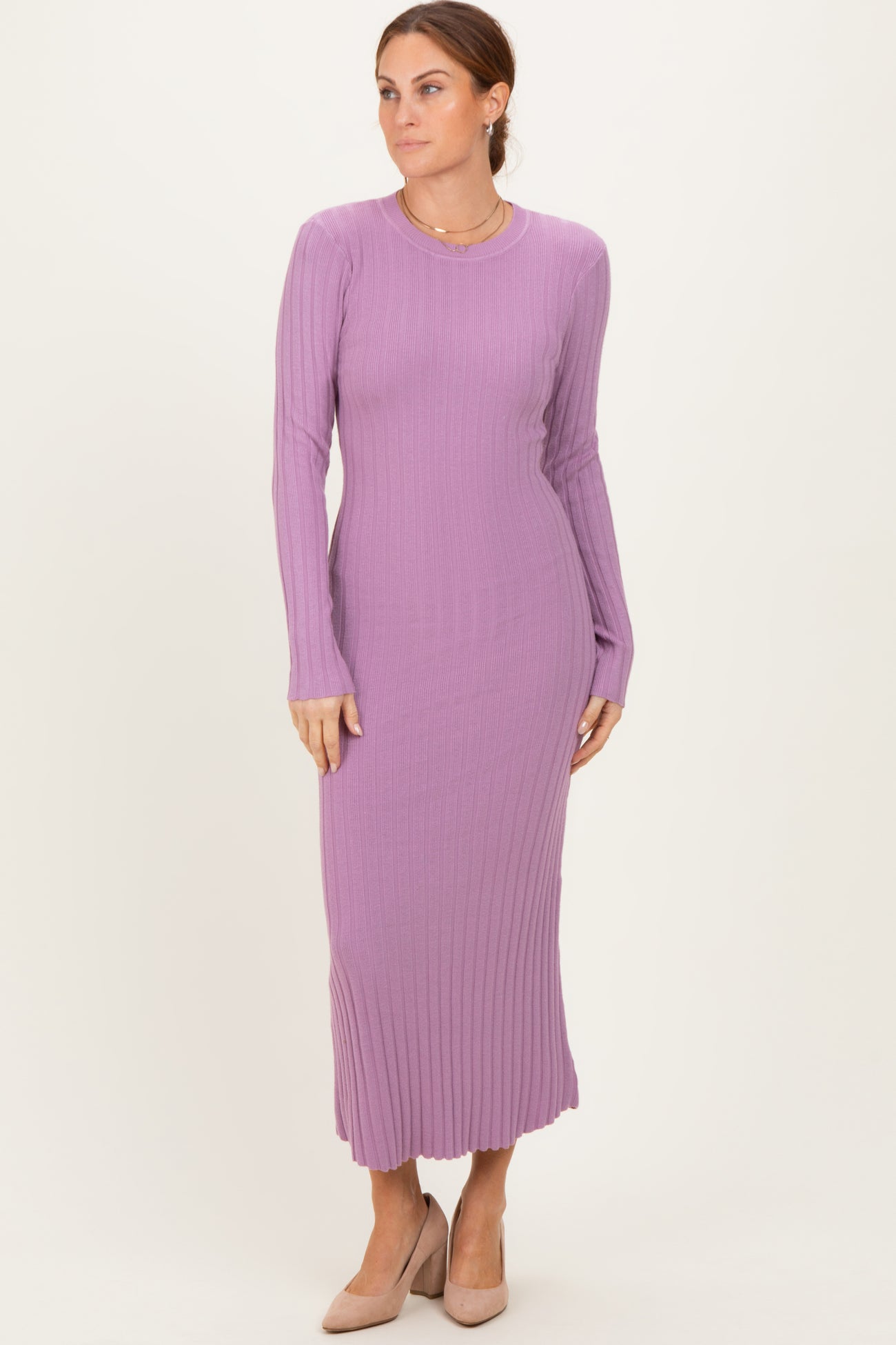 woman wearing a long sleeve ribbed purple maxi dress and beige heels