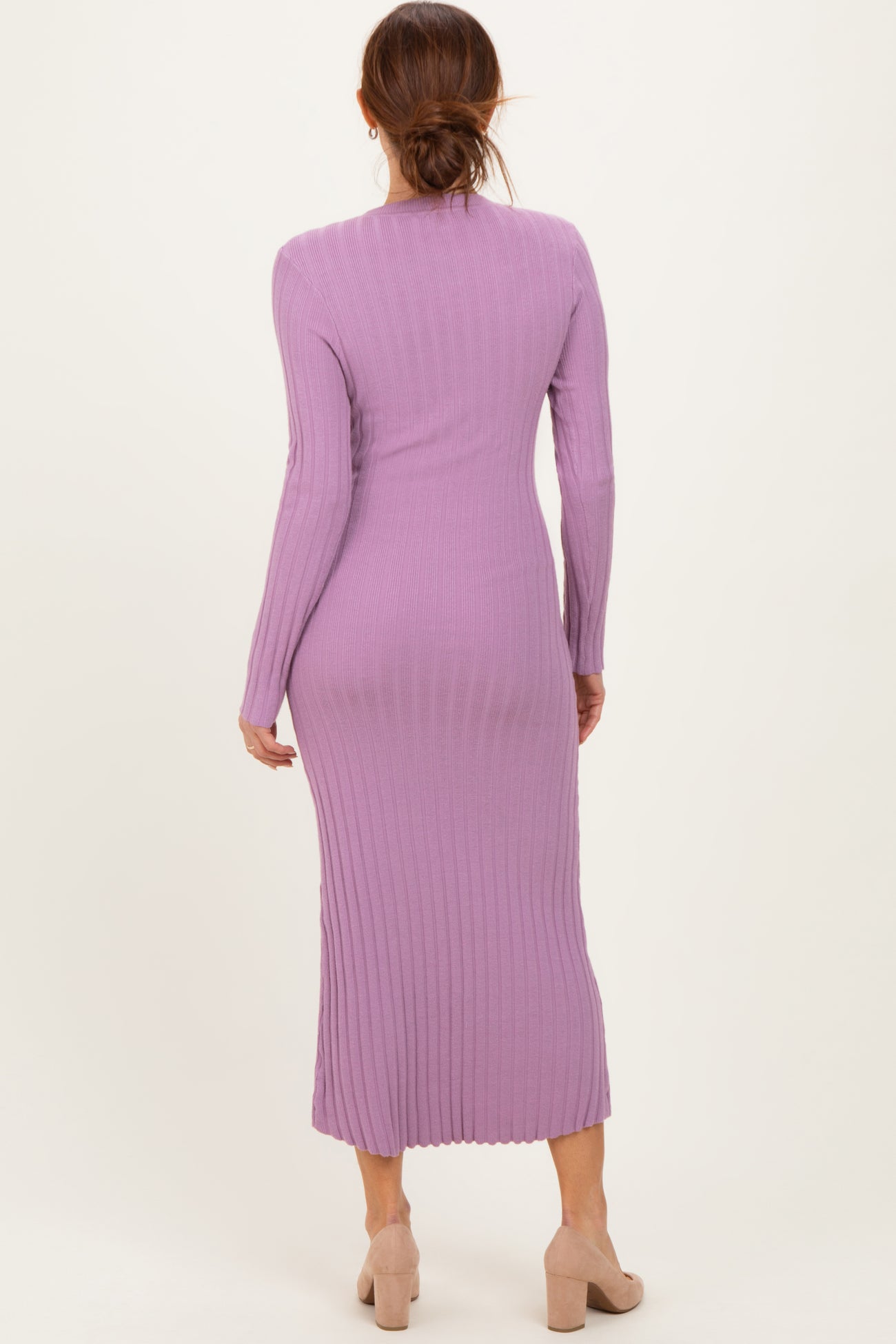 woman wearing a long lavender ribbed knit dress with long sleeves and a fitted silhouette, seen from the back
