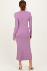 woman wearing a long lavender ribbed knit dress with long sleeves and a fitted silhouette, seen from the back