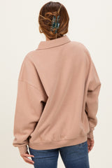 woman wearing a cozy blush oversized pullover sweatshirt with a collar and back views