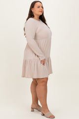 woman wearing a light beige ribbed long sleeve plus size dress with a tiered skirt and heeled sandals