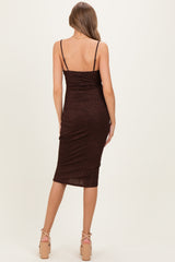 woman wearing a brown sparkly maternity dress with adjustable spaghetti straps and a form-fitting silhouette