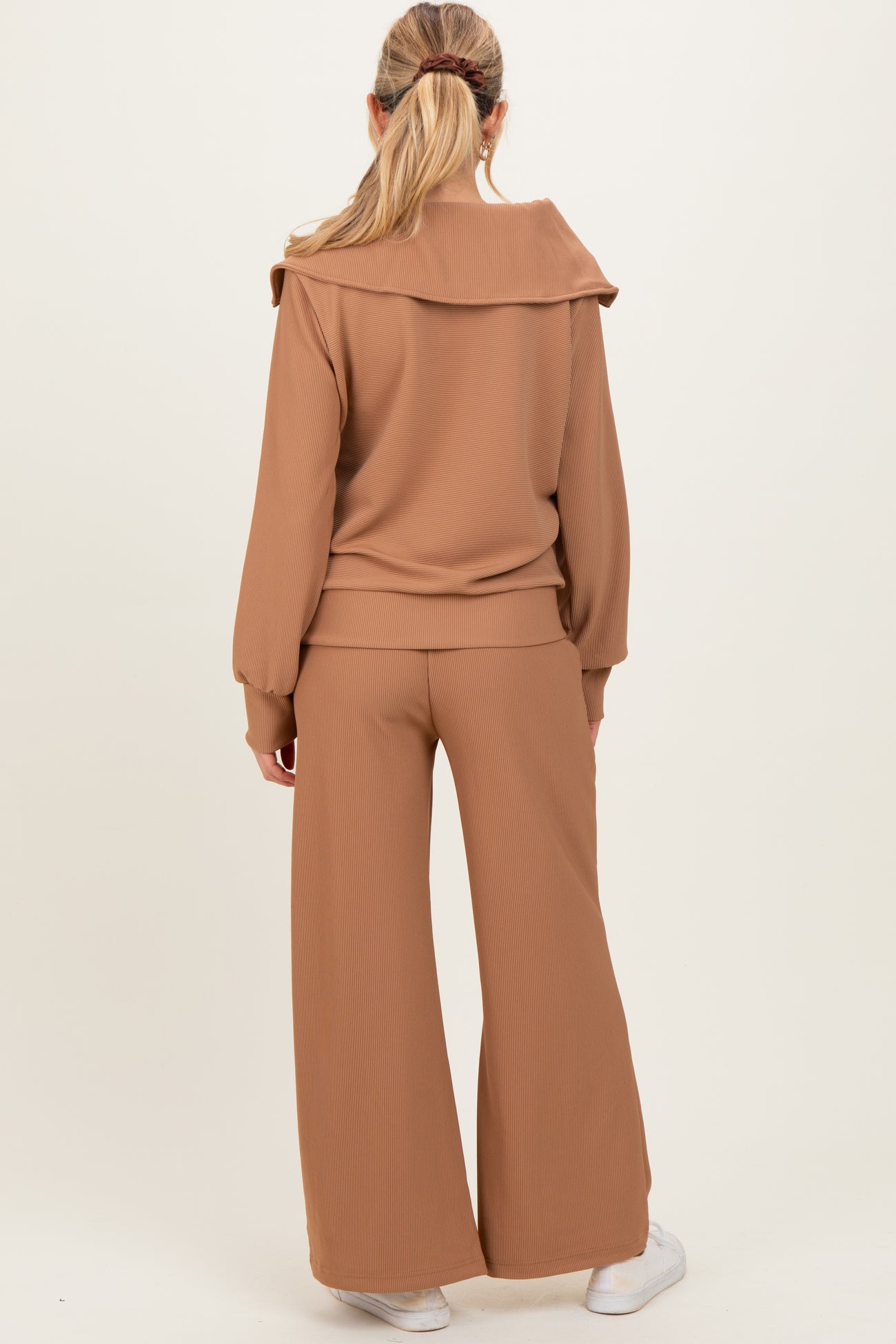 woman wearing a brown maternity sweater with oversized collar and matching wide-leg pants