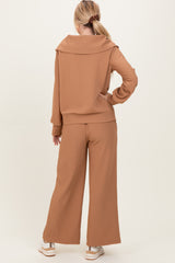 woman wearing a brown ribbed two-piece outfit with a stylish off-shoulder top and wide-leg pants from the back