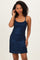 woman wearing a navy blue sparkling mini dress with thin spaghetti straps