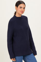 woman wearing a dark navy chunky knit sweater with a relaxed fit and long sleeves