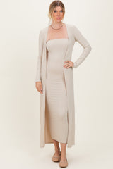 woman wearing a beige ribbed maxi dress with a long open cardigan and nude flats.