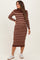 woman wearing a brown and striped long sleeve maternity dress with a fitted silhouette and relaxed fit