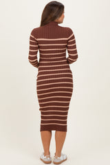 woman wearing a rust and beige striped maternity dress with a fitted silhouette and long sleeves, showing a baby bump