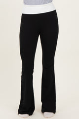 woman wearing black flared yoga pants with a white waistband