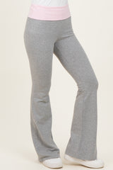 woman wearing gray flared sweatpants with a light pink waistband