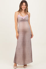 woman wearing a leopard print maternity maxi dress with pink lace trim and showing her baby bump