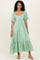 woman wearing a mint green short sleeve maxi dress with a ruched bust and tiered ruffle hem