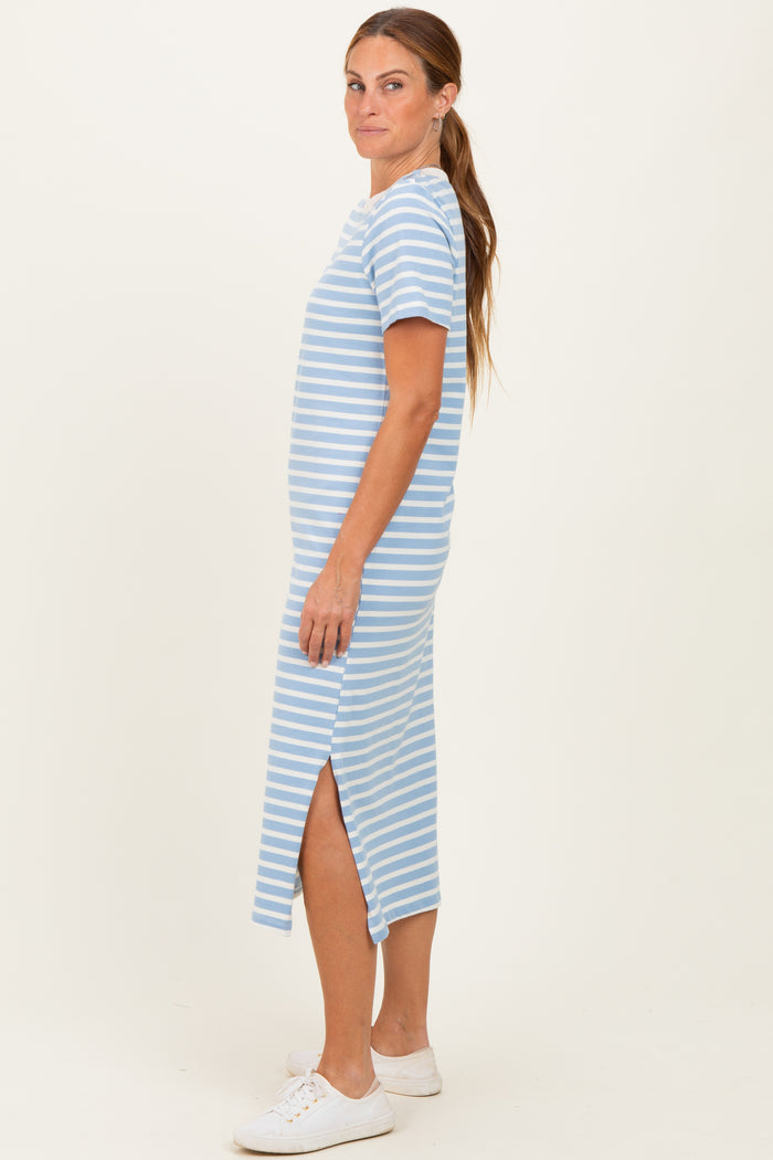 woman wearing a blue and white striped midi t-shirt dress with side slits and white sneakers
