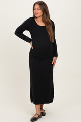 woman wearing a black long sleeve maternity dress with tie details and visible baby bump