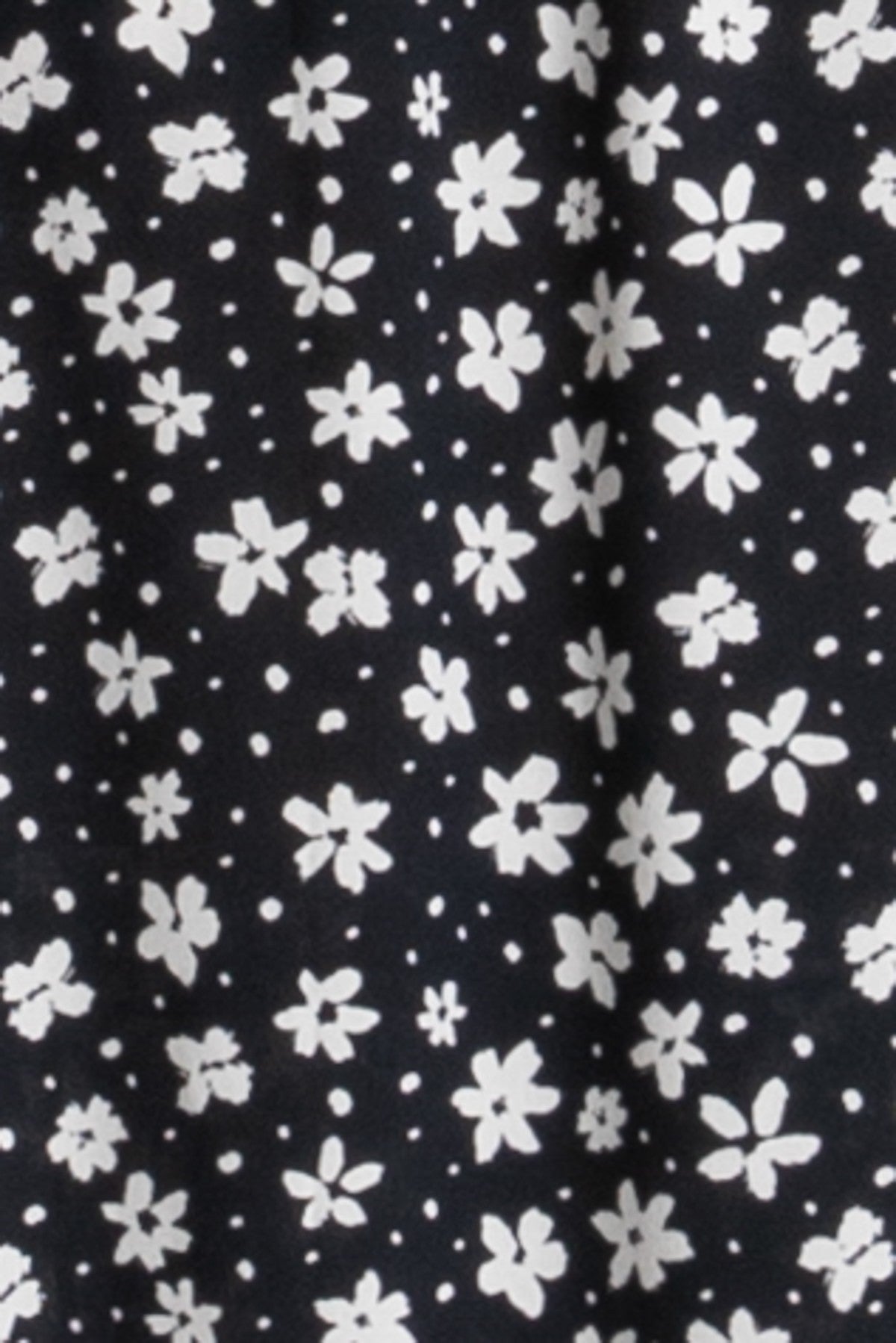 black floral print fabric with white flowers on a dark background