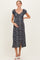 woman wearing a black floral midi maternity dress and holding her baby bump