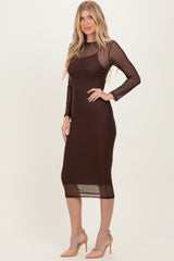 woman wearing a brown long sleeve midi dress with sheer dotted detailing and a fitted silhouette