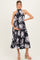 woman wearing a black floral maternity dress with a halter neckline and a visible baby bump