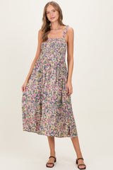 woman wearing a floral print maternity maxi dress with smocked bodice and adjustable straps