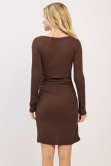 woman wearing a brown fitted long sleeve dress with a ribbed texture, showing the back view