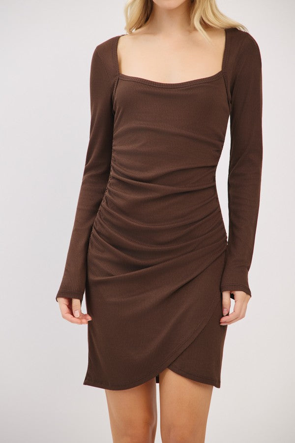 woman wearing a brown long sleeve bodycon dress with a square neckline and ruching detail on the front