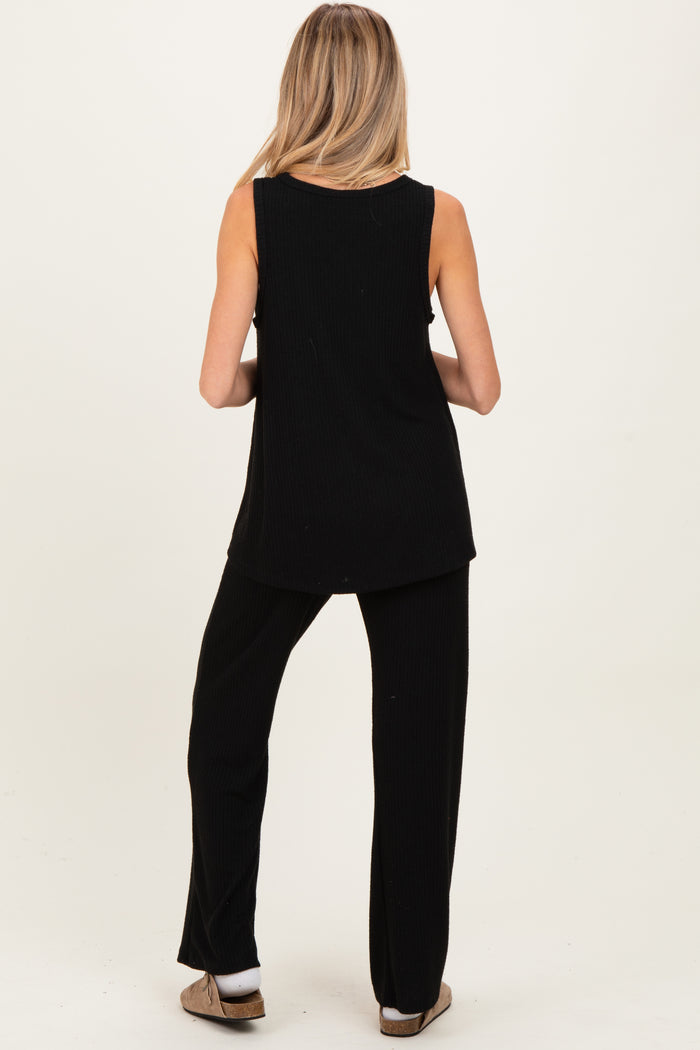 woman wearing a black ribbed maternity tank top and matching pants, showing her back with a relaxed fit