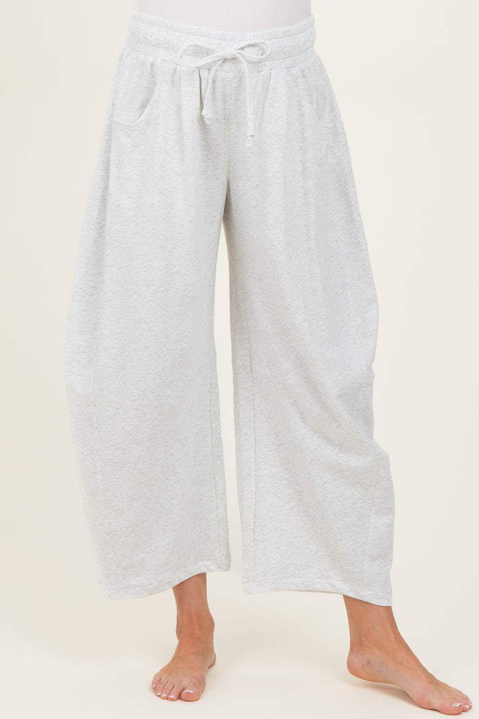 woman wearing light gray wide leg maternity pants with drawstring and side pockets