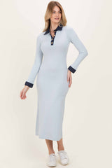 woman wearing a light blue long sleeve ribbed midi dress with a navy collar and buttons, paired with white sneakers