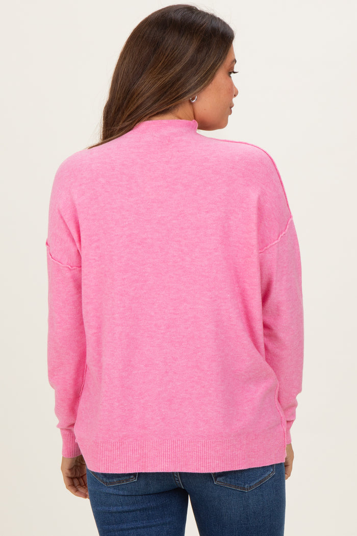 woman wearing a pink maternity sweater with a relaxed fit and ribbed hem, view from the back