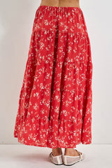 woman wearing a flowy red floral tiered maxi skirt with a comfortable elastic waistband and sandals