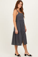 woman wearing a charcoal gray button-up midi dress with a tiered hem and thin straps