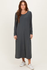 woman wearing a long grey maxi dress with long sleeves and a relaxed fit