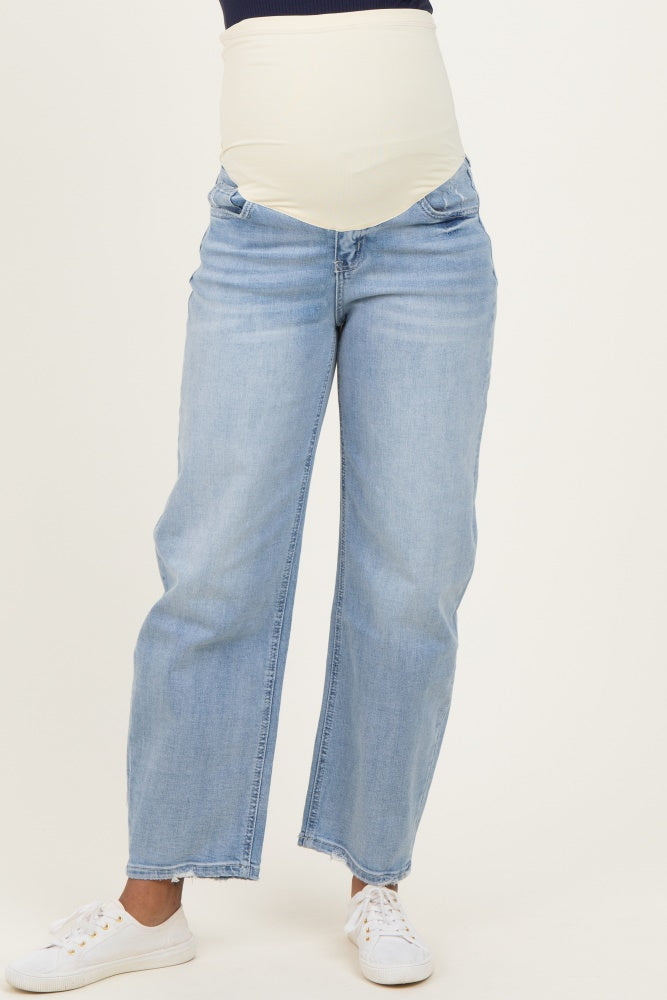 woman wearing light blue maternity jeans with a supportive belly panel and straight leg fit