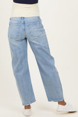 woman wearing light blue maternity jeans with a relaxed fit and rolled cuffs